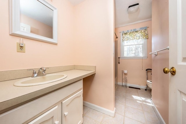 full bathroom featuring tile patterned flooring, walk in shower, baseboards, vanity, and toilet