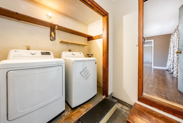 clothes washing area featuring baseboards, laundry area, and independent washer and dryer
