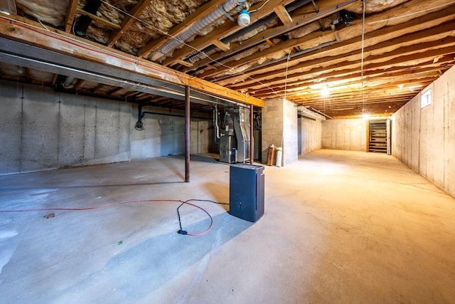 unfinished below grade area featuring heating unit