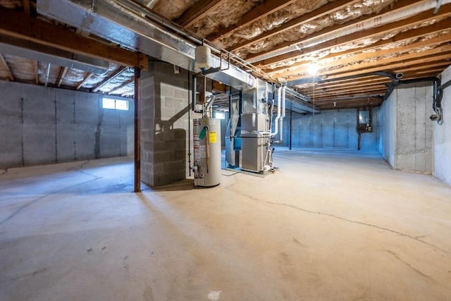 basement featuring heating unit, gas water heater, and electric panel
