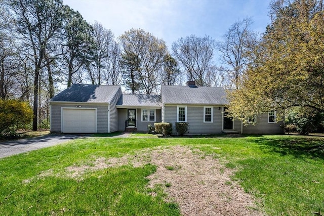 single story home featuring roof with shingles, an attached garage, aphalt driveway, a front yard, and a chimney
