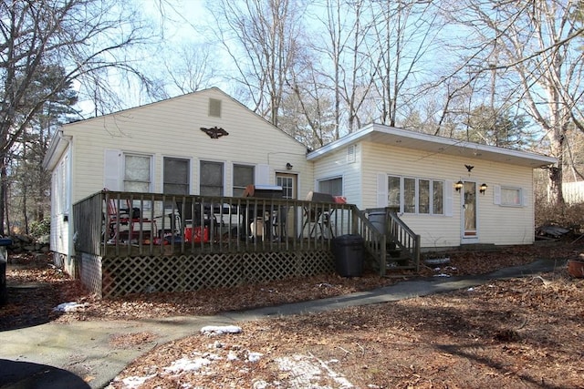 back of house with a deck