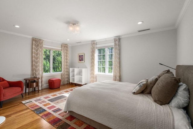 69 Princeton Rd, Brookline, MA 02467 - bedroom featuring multiple windows, wood finished floors, crown molding, and recessed lighting