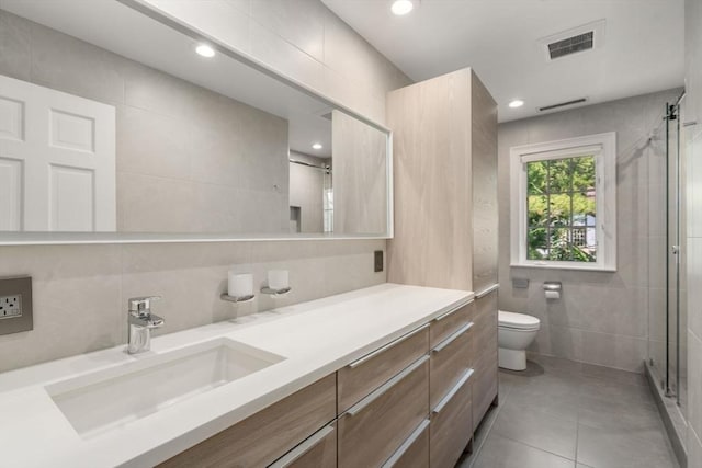69 Princeton Rd, Brookline, MA 02467 - full bath featuring tile walls, vanity, tile patterned flooring, a stall shower, and recessed lighting