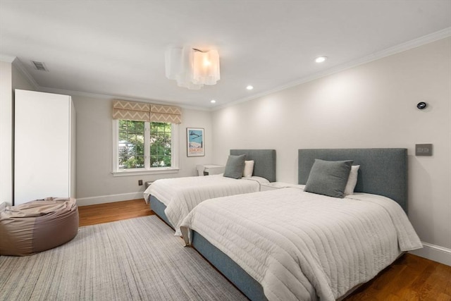 69 Princeton Rd, Brookline, MA 02467 - bedroom with wood finished floors, crown molding, and recessed lighting