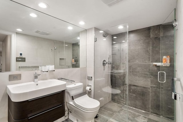 69 Princeton Rd, Brookline, MA 02467 - bathroom with tile walls, vanity, a stall shower, and recessed lighting