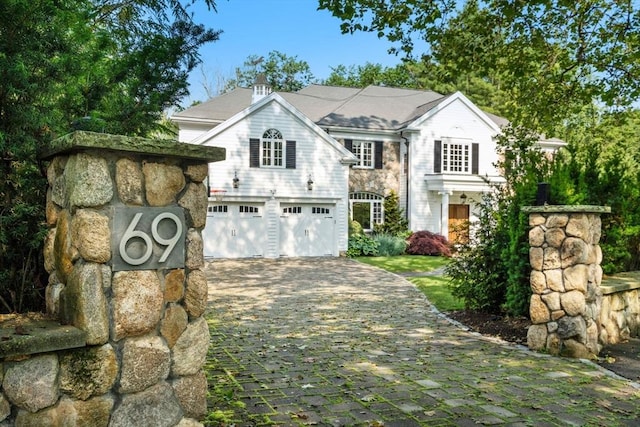 69 Princeton Rd, Brookline, MA 02467 - view of front of property featuring decorative driveway and a garage
