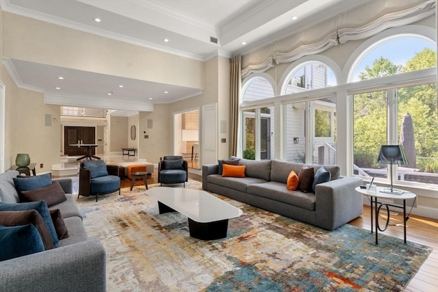 69 Princeton Rd, Brookline, MA 02467 - living room with wood finished floors, ornamental molding, recessed lighting, and a high ceiling