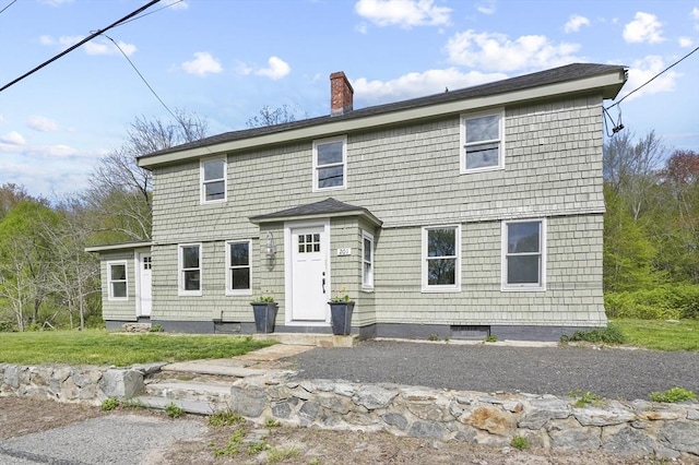 view of front of house featuring a chimney