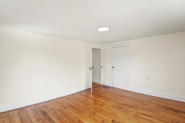 unfurnished room with light wood-style floors and baseboards