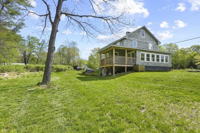 rear view of property with a lawn and a chimney