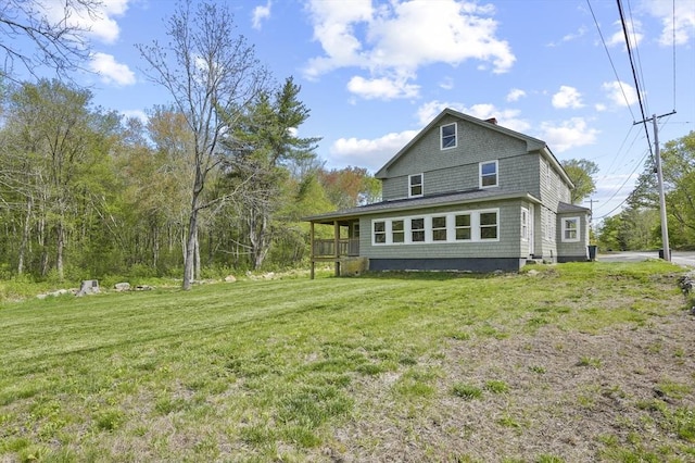 back of property featuring a yard