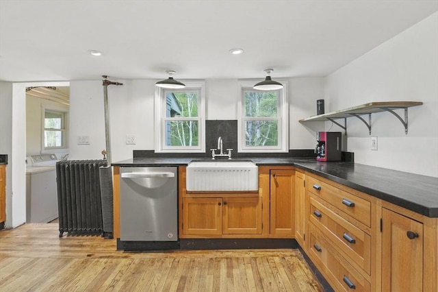 kitchen with stainless steel dishwasher, a sink, open shelves, washer and dryer, and dark countertops