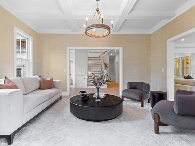 living room with beam ceiling, coffered ceiling, and a notable chandelier