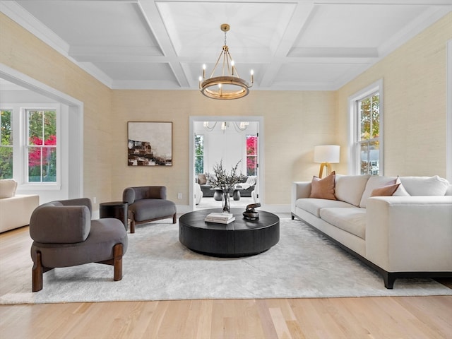 living room with beamed ceiling, coffered ceiling, hardwood / wood-style flooring, and a chandelier