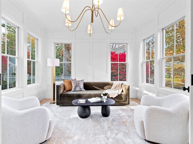 sunroom / solarium with a notable chandelier