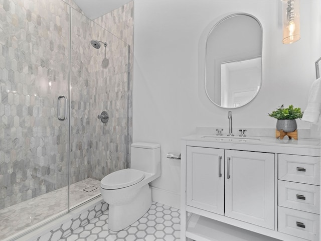 bathroom with vanity, tile patterned flooring, toilet, and walk in shower