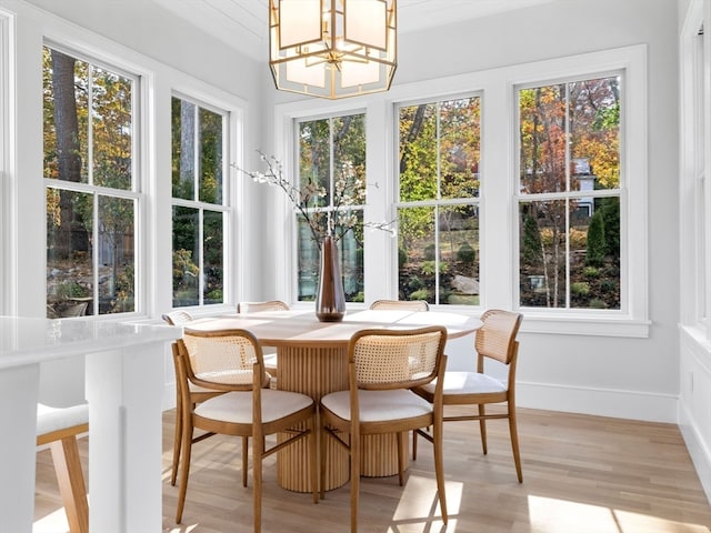 sunroom with a healthy amount of sunlight and a chandelier