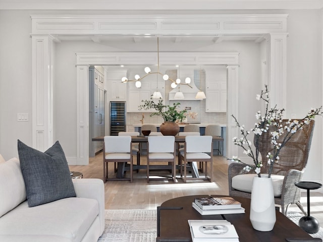 living room with an inviting chandelier and light wood-type flooring