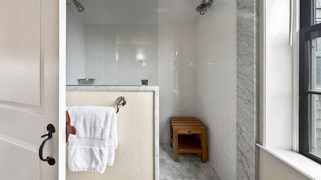 bathroom featuring tile walls and tiled shower