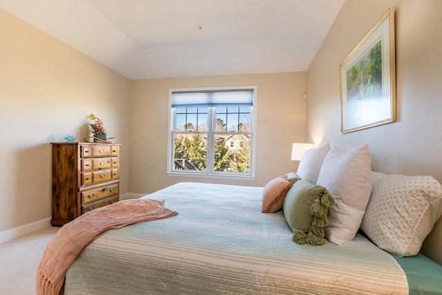 bedroom with vaulted ceiling and carpet flooring