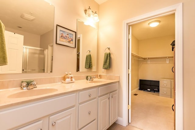 bathroom featuring vanity and a shower with door