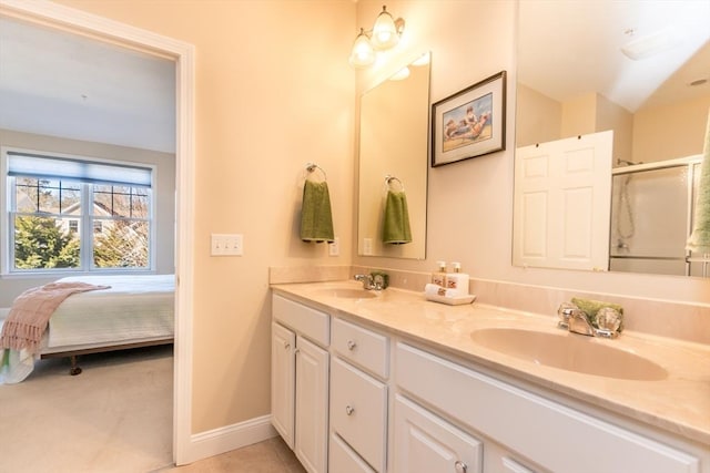 bathroom with tile patterned flooring, vanity, and a shower with door