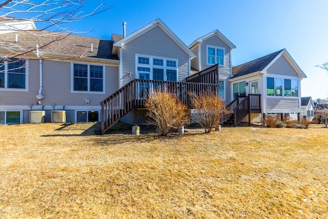 back of property featuring a deck, central AC, and a lawn