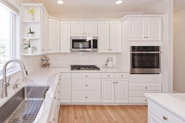 kitchen featuring white cabinetry, sink, and stainless steel appliances