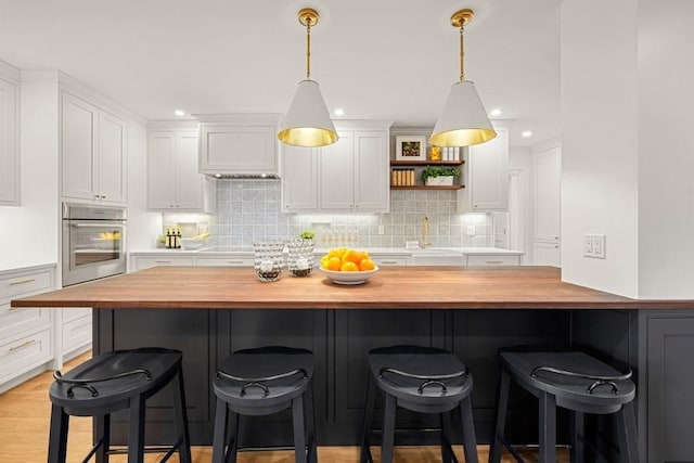 130 Mount Auburn St Unit 310, Cambridge, MA 02138 - kitchen featuring wood counters, oven, white cabinetry, decorative backsplash, and recessed lighting
