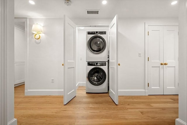 130 Mount Auburn St Unit 310, Cambridge, MA 02138 - washroom with stacked washer / dryer, light wood-style floors, and recessed lighting