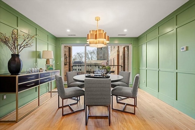 130 Mount Auburn St Unit 310, Cambridge, MA 02138 - dining room with a decorative wall, light wood finished floors, and a chandelier