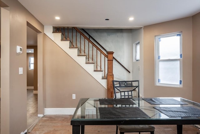 dining space with wood-type flooring