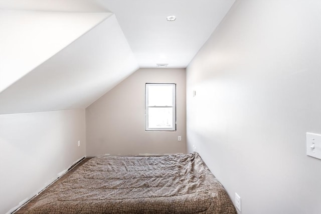 unfurnished bedroom with carpet floors and lofted ceiling