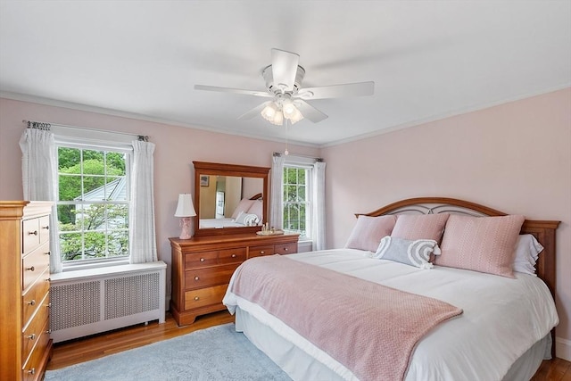 14 Glendale Ave, Melrose, MA 02176 - bedroom featuring radiator, wood finished floors, ornamental molding, and a ceiling fan