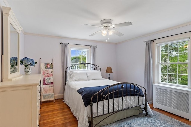 14 Glendale Ave, Melrose, MA 02176 - bedroom with radiator heating unit, wood finished floors, ornamental molding, a ceiling fan, and baseboards