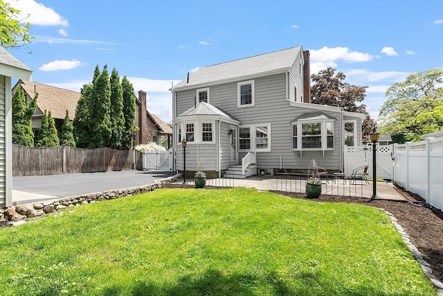 14 Glendale Ave, Melrose, MA 02176 - back of house with a patio, a gate, a chimney, and entry steps