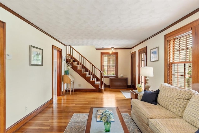 14 Glendale Ave, Melrose, MA 02176 - living area featuring baseboards, wood finished floors, ornamental molding, and stairs