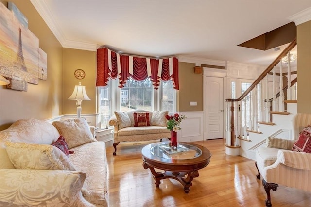 living room with hardwood / wood-style floors and ornamental molding