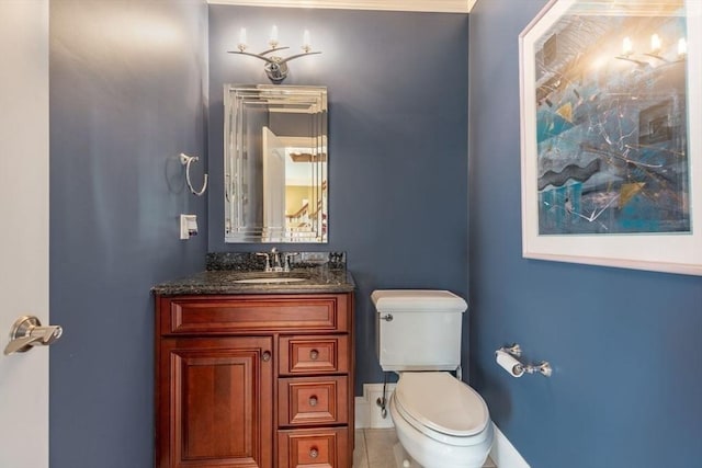 bathroom featuring tile patterned floors, vanity, toilet, and crown molding