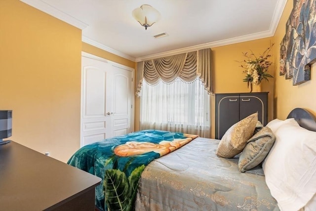 bedroom with a closet and crown molding