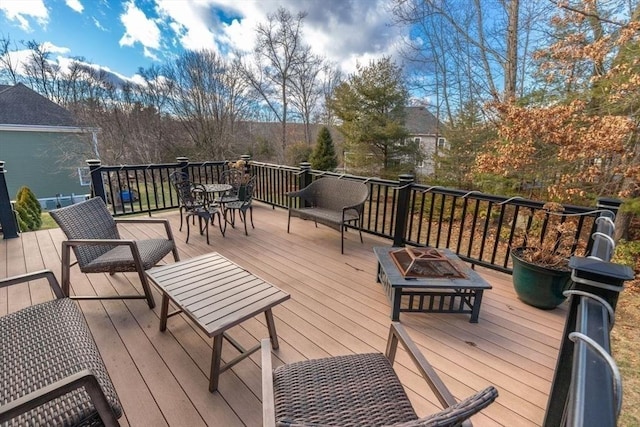 wooden deck with a fire pit