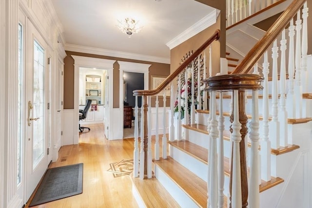 entrance foyer featuring light hardwood / wood-style floors and crown molding