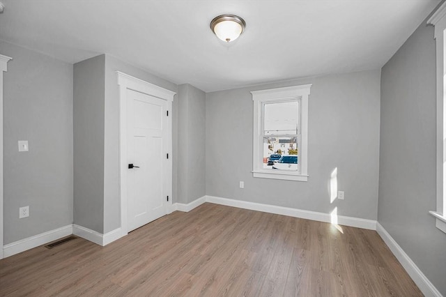 unfurnished room with light wood-type flooring