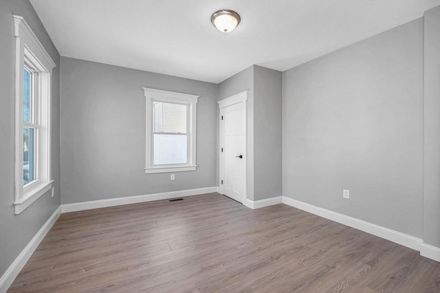 unfurnished room with wood-type flooring