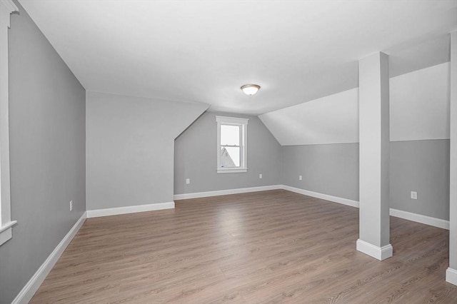 bonus room with light hardwood / wood-style flooring and vaulted ceiling