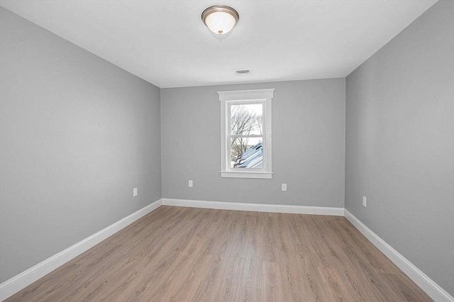 unfurnished room with light hardwood / wood-style floors