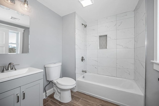 full bathroom featuring vanity, toilet, and tiled shower / bath