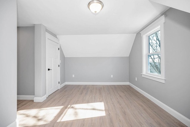 bonus room with lofted ceiling and light hardwood / wood-style flooring