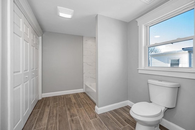 bathroom featuring shower / bathtub combination and toilet